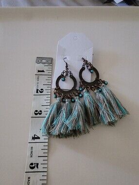 These are Boho-style dangle earrings featuring bronze-toned faux torquise beads
